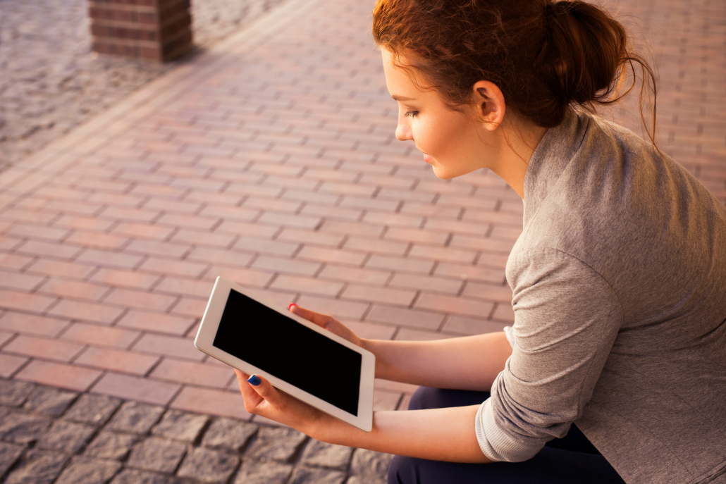 woman reading ipad Woman Signing Up For Our Newsletter